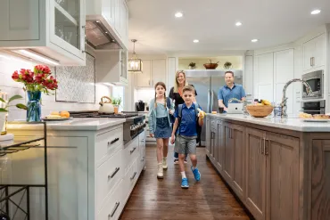 kids leaving for school in the kitchen as parents watch on